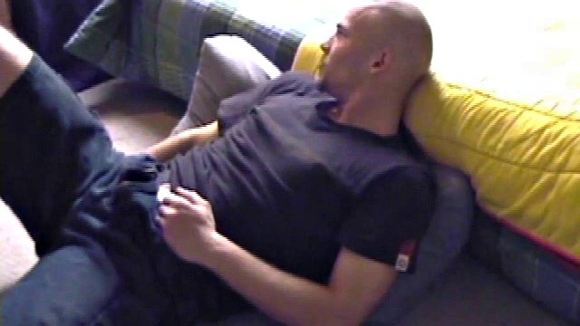 Stephen starts by unzipping and pulling out his dick, to work on a boner. Naked, he lies on his back, lubes himself up and starts stroking seriously. He changes hands, tightens his grip and comes like a spray all over her chest.