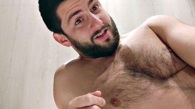 An intimate moment of a loving guy in first person - a beautiful smile on a hairy chest