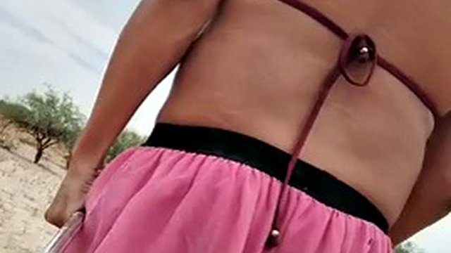 Sweet hot shemale in miniskirt, bra and red heels walks sexy in public