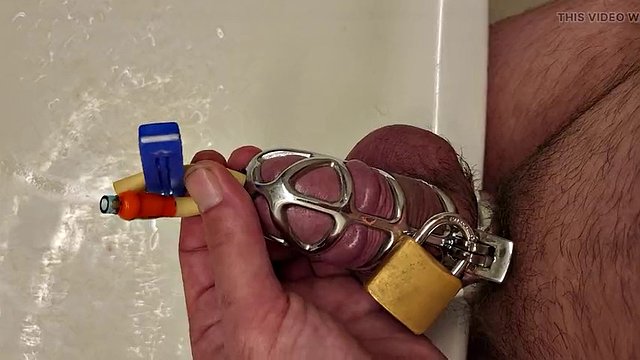 Pissing with a catheter locked in a chastity cage