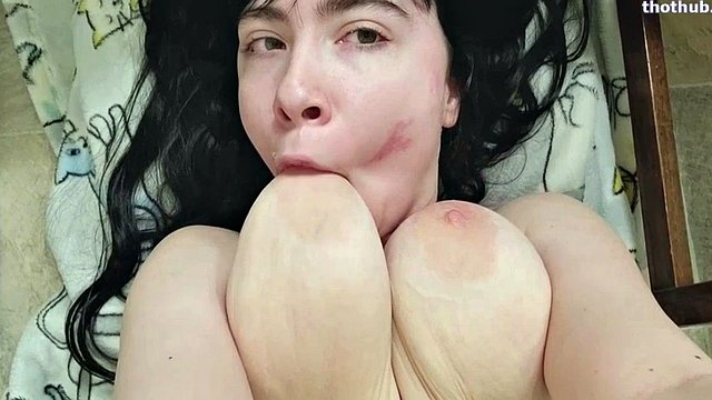 Sucking own saggy tits