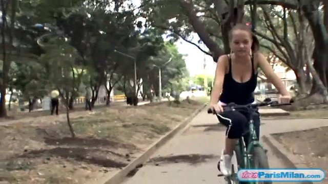 Busty solo teen riding her bike through the park