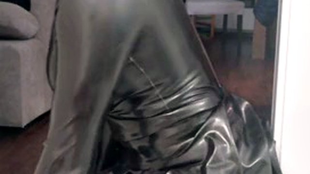 Rubber latex sissy in gas mask plays with a dildo