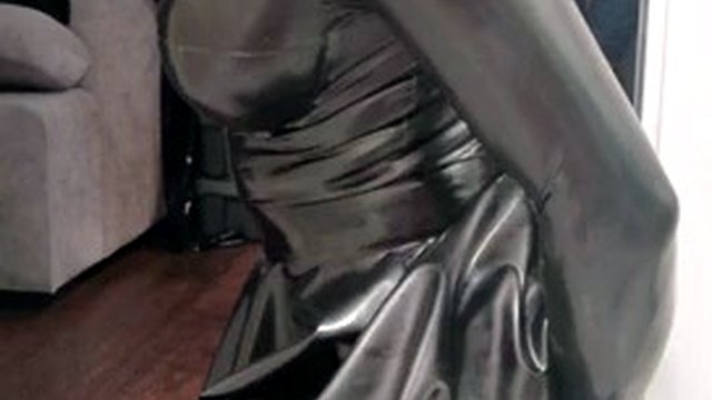 Rubber latex sissy in gas mask plays with a dildo