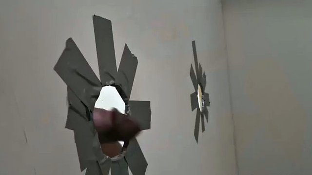 Amateur housewife sucking a massive black dick through a glory hole