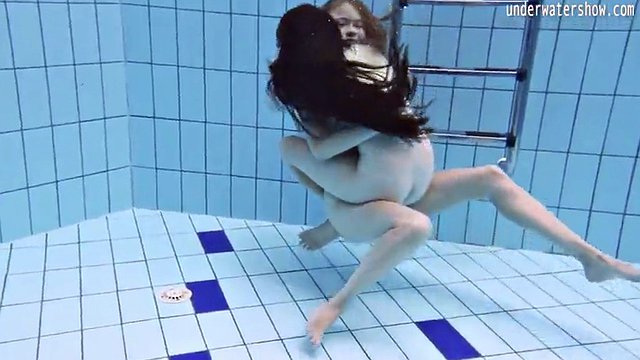 Enjoying underwater lesbian sex with a redhead