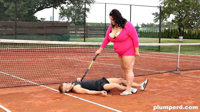 obese woman facesits on her trainer at the tennis court