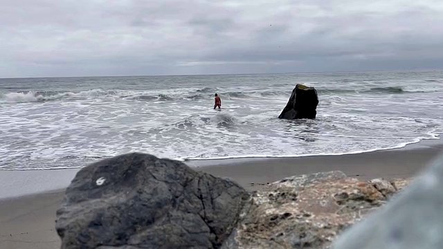 裸の人里離れたビーチで海を泳ぐ裸と私