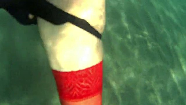 red stocking in the sea on a public beach