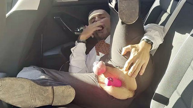 Kinky gentleman slave spread legs and plays with his ass in a car in public